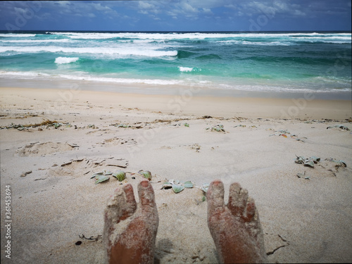 Sandy feet of a hiker. Resting on a tranquil deserted beach. Bibbulmun track Western Australia. photo