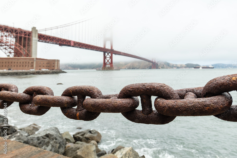 Rusty chain with the golden gate bridge in background Rusty chain with the golden gate bridge in background