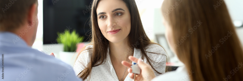 Portrait of joyful businesswoman sitting at modern workplace and discussing sale bargain. Property agent looking at client with concentration and calmness. Real estate concept Portrait of joyful businesswoman sitting at modern workplace and discussing sale bargain. Property agent looking at client with concentration and calmness. Real estate concept