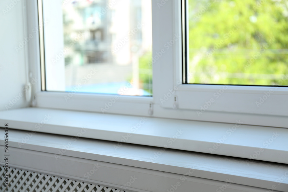 Fototapeta premium Closeup view of window with empty white sill