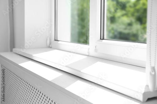 Closeup view of window with empty white sill