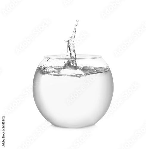 Splash of water in round fish bowl on white background photo