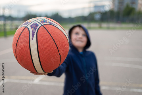 boy holding a basket ball, hand close up