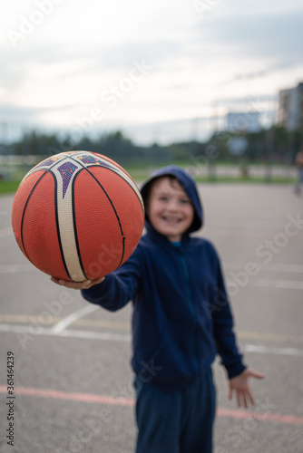 boy holding a basket ball, hand close up