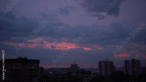 Beautiful Sunset Over The City, Scarlet Color. City Silhouette Under The Clouds and Beautiful Sky. Timelamps. photo