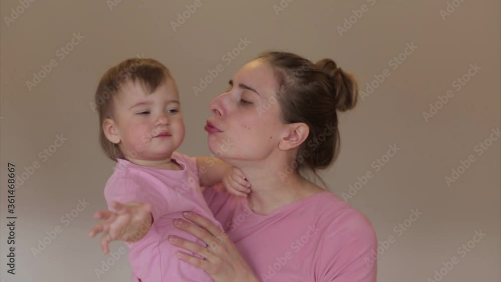 mother's day. mom holds child in his arms and hugs them. baby kiss a woman. I love you! mother's day. mom holds child in his arms and hugs them. baby kiss a woman. I love you!