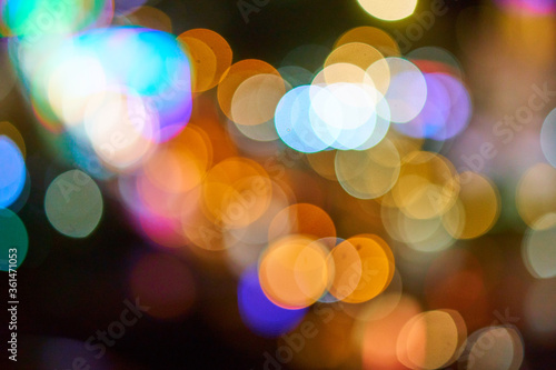 Beautiful bokeh circles from out of focus street lights. Abstract background.