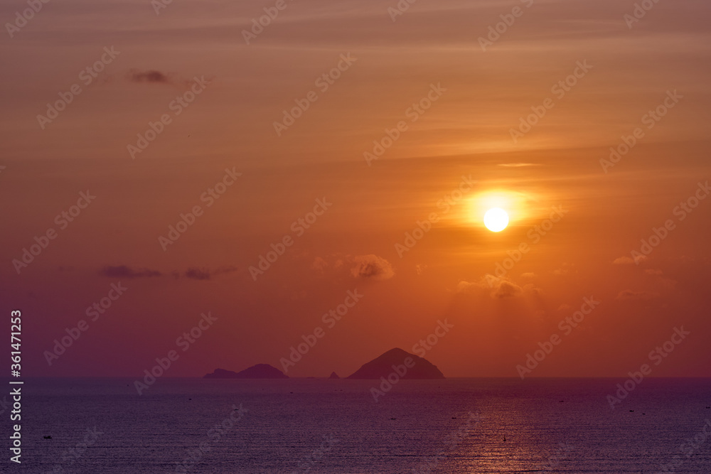 Spectacular sunrise over the tropical island. Calm seascape.