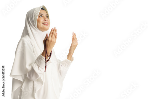 Muslim young woman praying open her arm isolated over white background