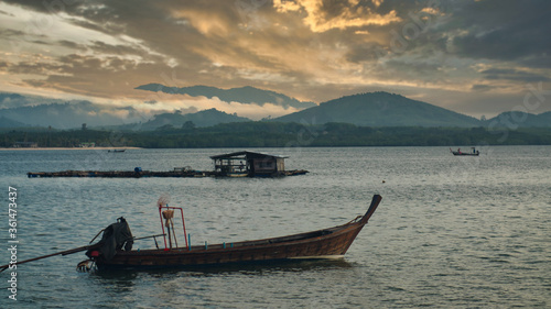 Beautiful landscape in Phuket with fishing boat at sunset