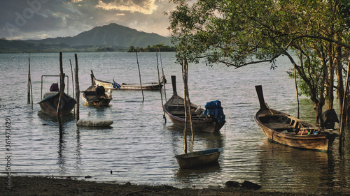 Beautiful landscape in Phuket with fishing boats at sunset