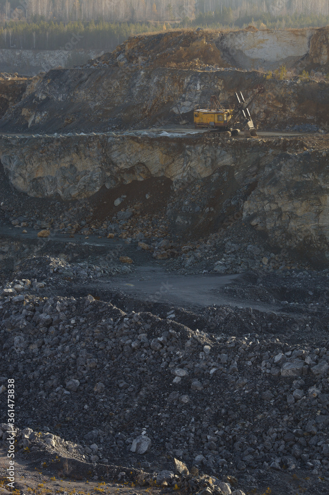 Mining excavator in a stone quarry. Mining industry. Mining excavator in a stone quarry. Mining industry.