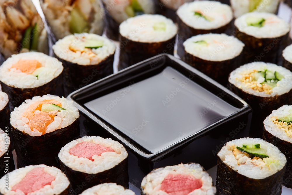 Various kinds of sushi roll set served on cutting board. Japanese food Various kinds of sushi roll set served on cutting board. Japanese food