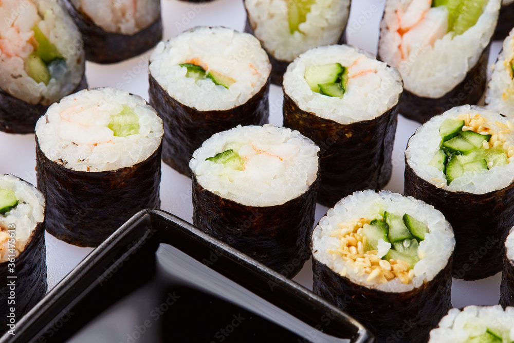 Various kinds of sushi roll set served on cutting board. Japanese food Various kinds of sushi roll set served on cutting board. Japanese food