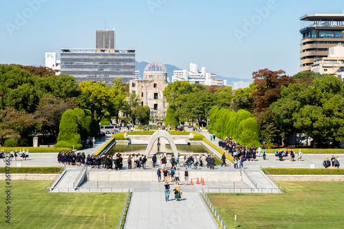 HIROSHIMA, Japan. Wide view of The Hiroshima Peace Memorial Park and Atomic Bomb Dome with tourists. photo