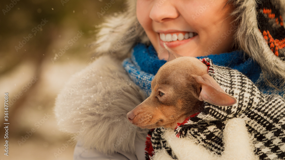 Woman hug warming her little dog in winter Woman hug warming her little dog in winter