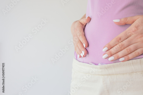 Wallpaper Mural Pregnant woman in the early stages touches the belly with her hands. First and second trimester of pregnancy Torontodigital.ca