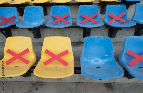 Social distance concept;Chair in stadium. Keep space between chair during Coronavirus (Covid-19) pandemic Social distancing, New normal, Healthcare concept.