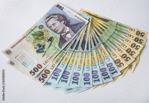 Many 500, 100 and 50 RON or lei romanian banknotes on white background. Romanian currency.