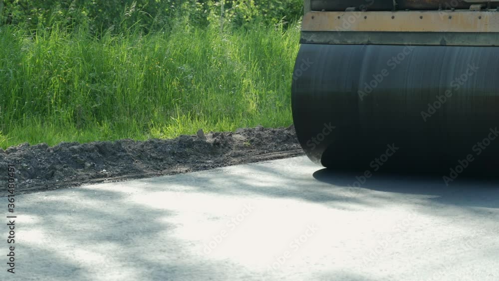 The large working machine of the skating rink makes a new asphalt. Road repair. Close-up The large working machine of the skating rink makes a new asphalt. Road repair. Close-up