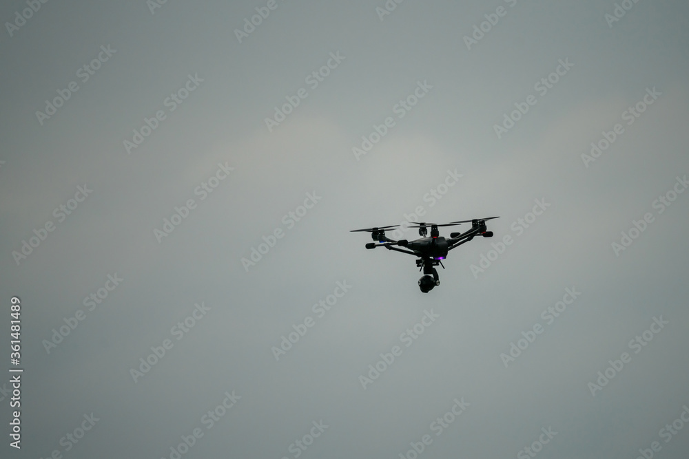 Drone flying in front of a cloudy sky Drone flying in front of a cloudy sky