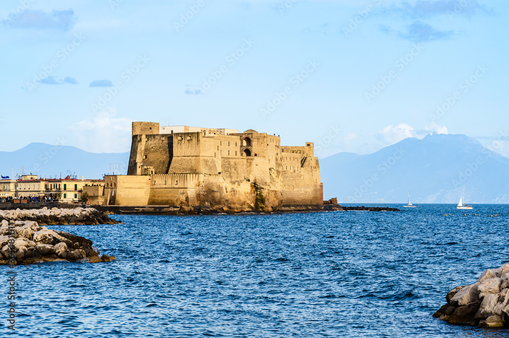 Ovo Castle in Naples, Italy on the peninsula of Megaride in the Gulf of Naples Naples with mount Vesuvius in the background