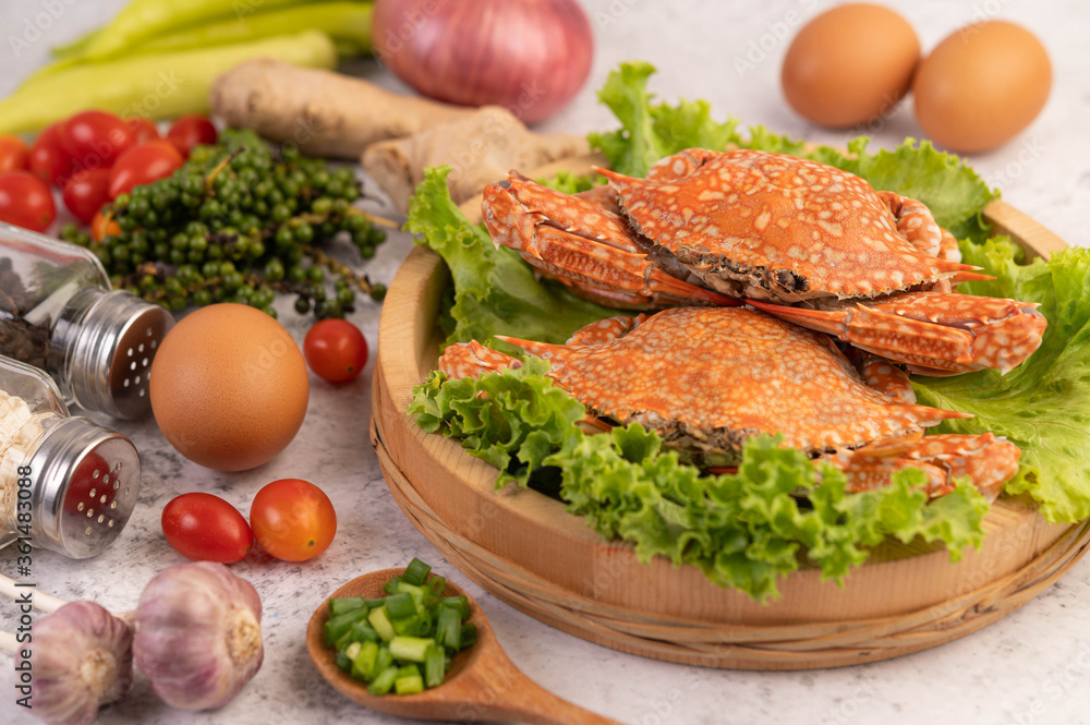 One crab is cooked on lettuce in a dish. One crab is cooked on lettuce in a dish.