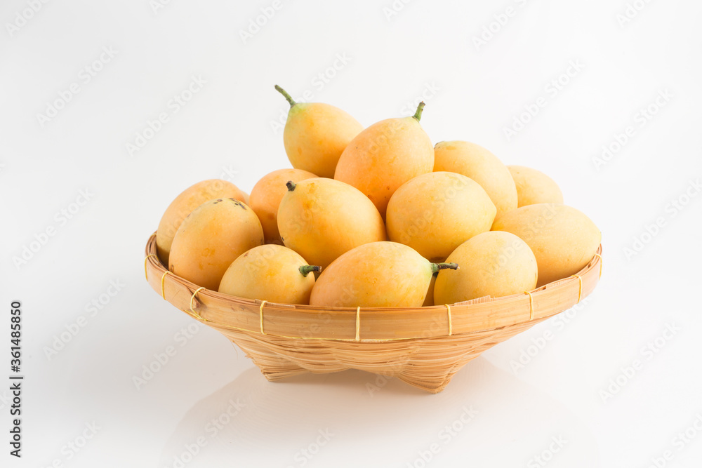 yellow Marian plum in a basket