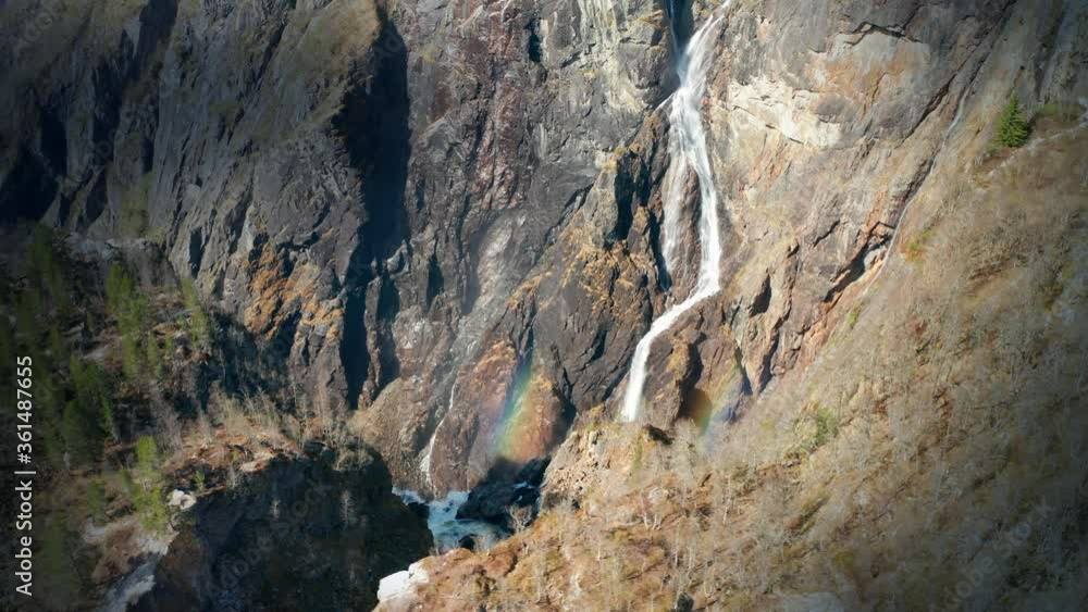 Aerial view of the famous Voringfossen waterfall in Norway. Thin streams of turbulent whitewater falling down from the dark cliffs, foaming and raising clouds of water spray. Aerial view of the famous Voringfossen waterfall in Norway. Thin streams of turbulent whitewater falling down from the dark cliffs, foaming and raising clouds of water spray.