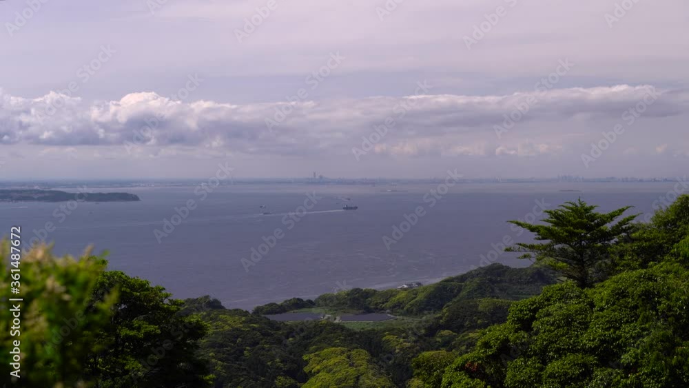 View Of The Blue Ocean With A Boat And The Yokohama City In The Distance In Japan. -wide shot View Of The Blue Ocean With A Boat And The Yokohama City In The Distance In Japan. -wide shot
