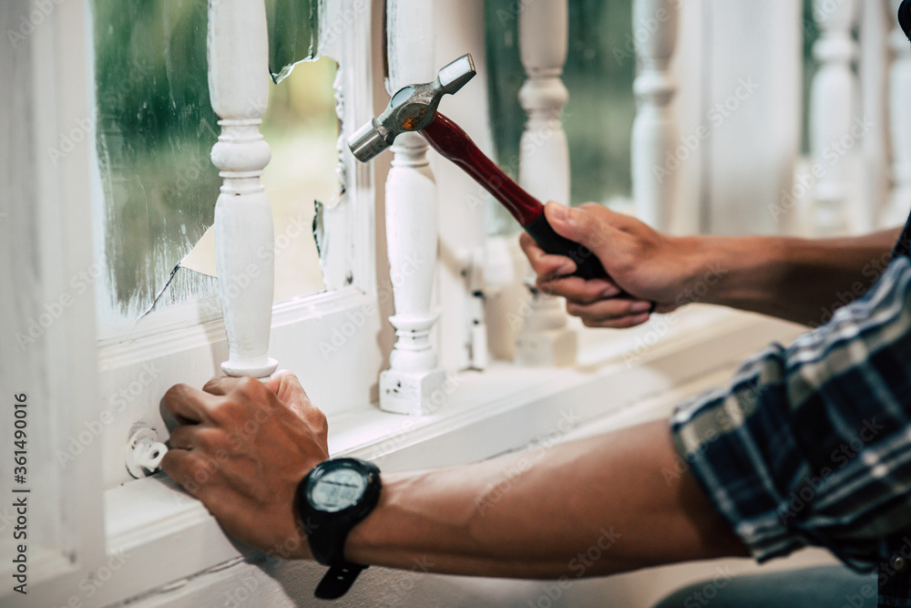 Fototapeta premium The carpenter holds the hammer and nails.