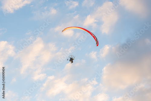 paragliders high in the sky above the ground