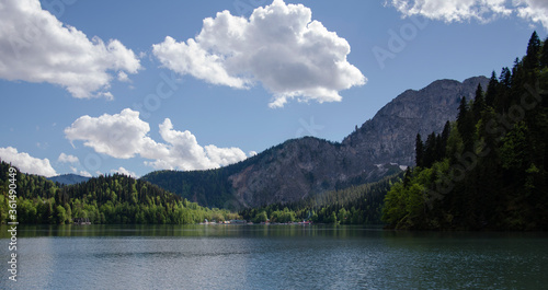 Snow-capped mountains in the forest on a clear summer day.