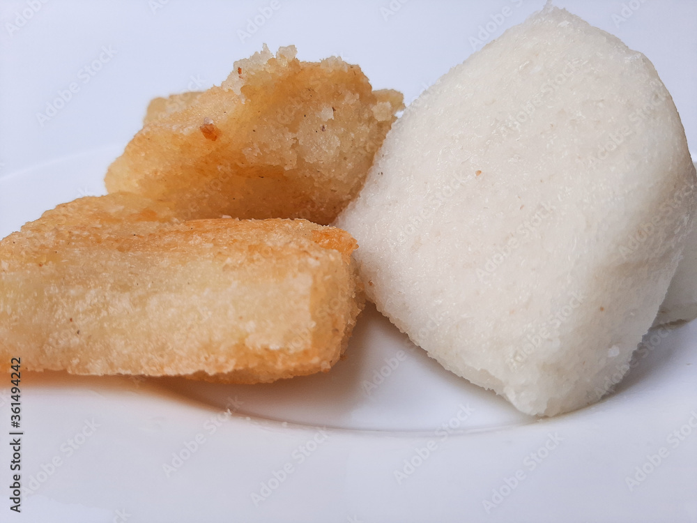 Jadah ketan, is a traditional snack from Indonesia. Made from sticky rice and grated coconut. Comparison before and after fried. On a white plate, isolated in white background Jadah ketan, is a traditional snack from Indonesia. Made from sticky rice and grated coconut. Comparison before and after fried. On a white plate, isolated in white background