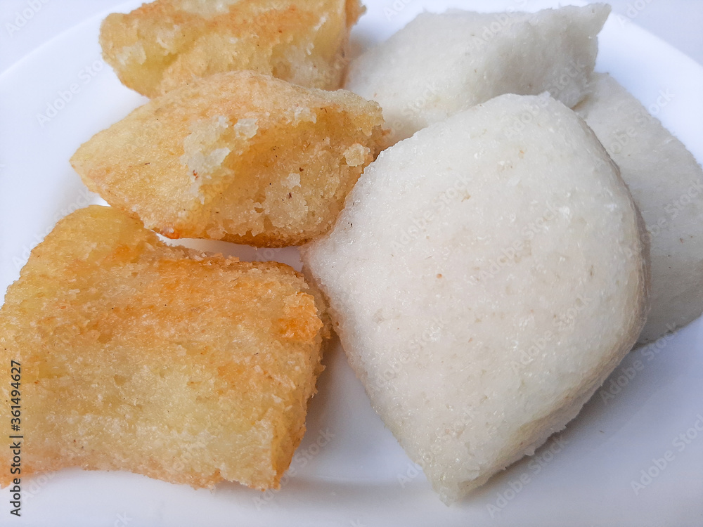 Jadah ketan, is a traditional snack from Indonesia. Made from sticky rice and grated coconut. Comparison before and after fried. On a white plate, isolated in white background