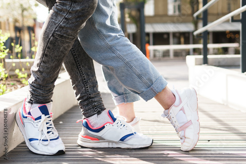Couple wearing sneakers in embrace