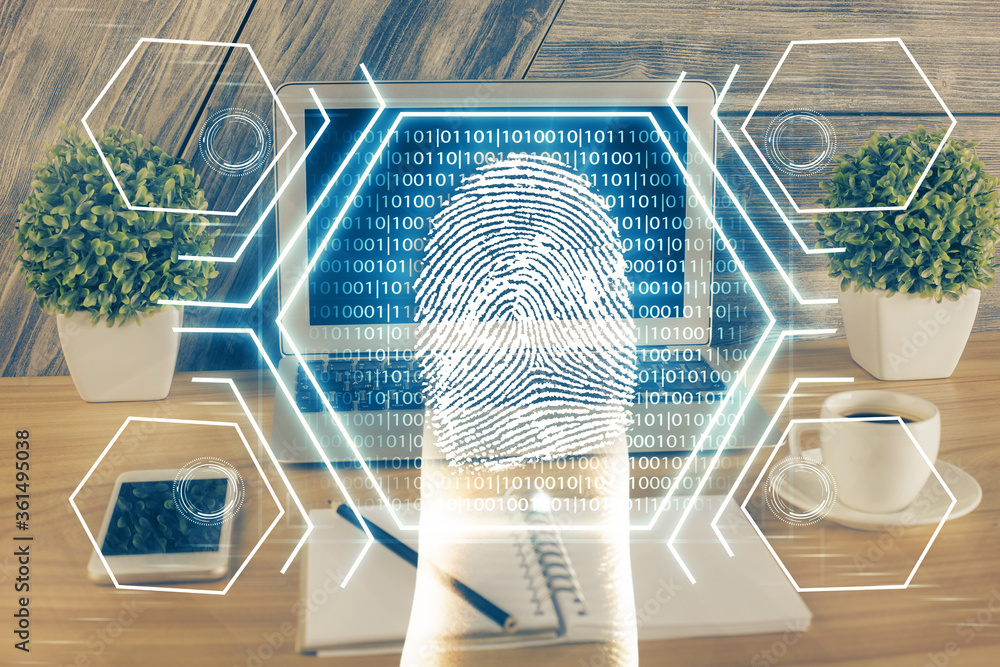 Fototapeta premium Computer on desktop in office with finger print drawing. Double exposure. Concept of business data security.