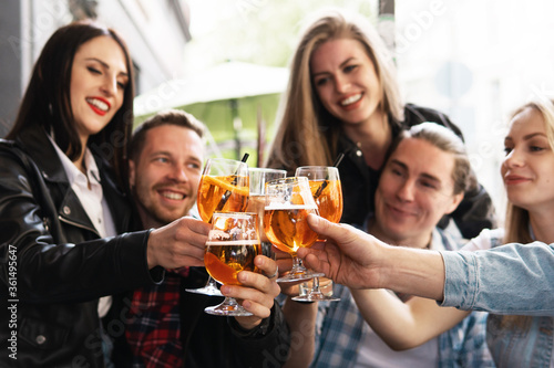 Group of friends celebrating meeting in the street bar