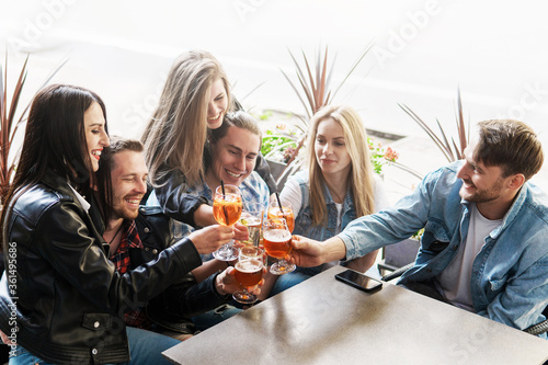 Group of friends celebrating meeting in the street bar