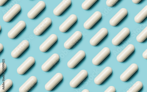 Pattern with white pills on blue background. Pharmaceutical industry background. Creative image.