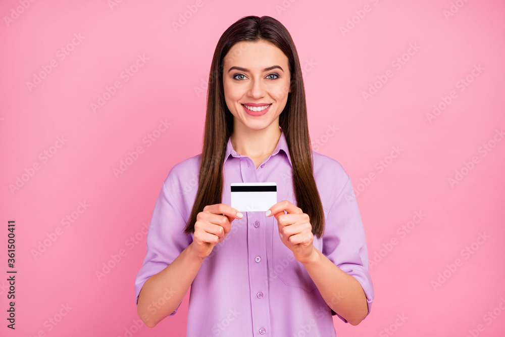 Close-up portrait of her she nice attractive lovely pretty charming confident cheerful cheery long-haired girl holding in hands demonstrating bank card isolated on pink pastel color background Close-up portrait of her she nice attractive lovely pretty charming confident cheerful cheery long-haired girl holding in hands demonstrating bank card isolated on pink pastel color background
