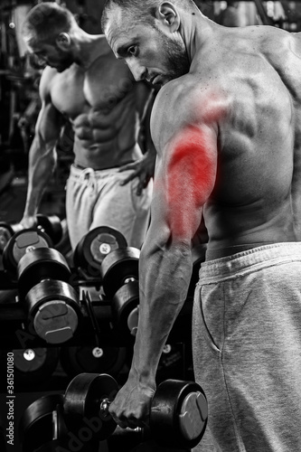 Triceps specialization in bodybuilding. Man during workout in the gym