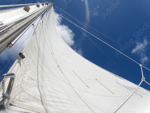 Yacht mast with the sail on the blue sky, Dominican Republic