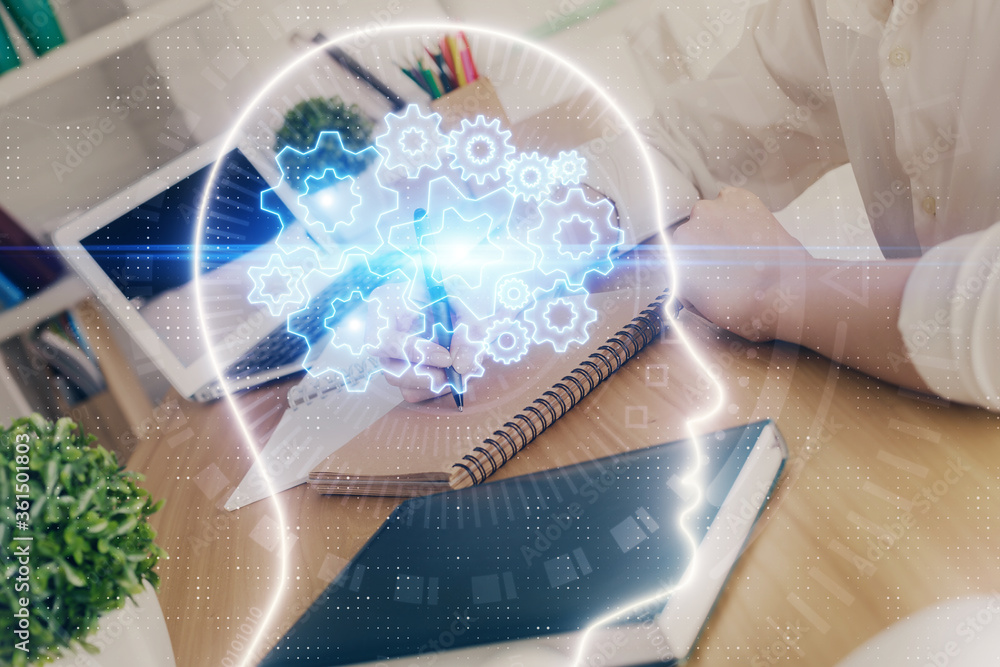 Multi exposure of writing hand on background with brain hologram. Concept of learning. Multi exposure of writing hand on background with brain hologram. Concept of learning.