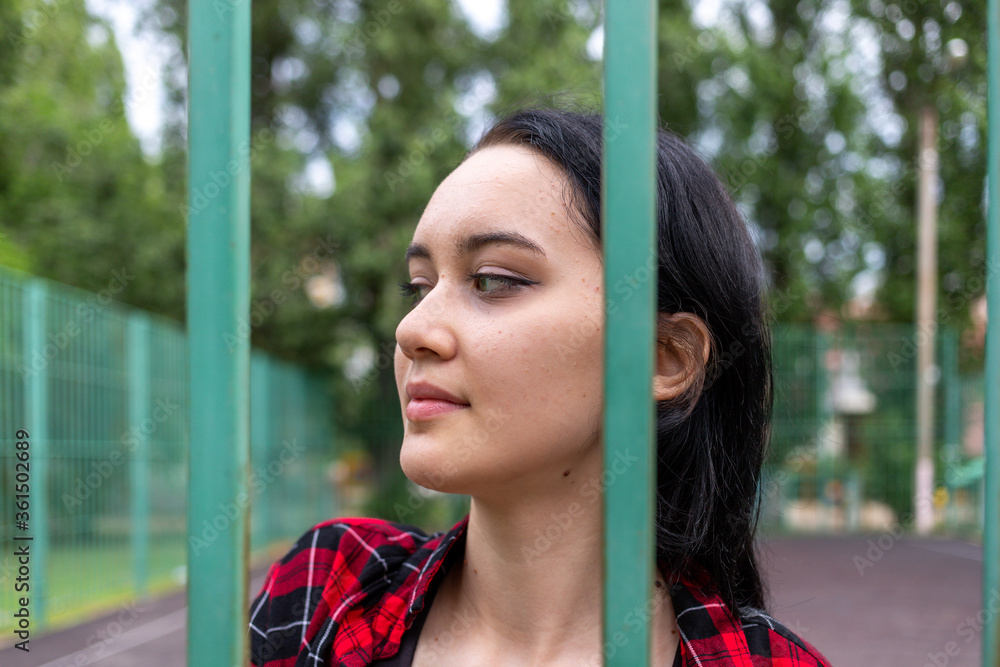 Beautiful young girl with expressive eyes on the school sports ground in the summer. High quality photo Beautiful young girl with expressive eyes on the school sports ground in the summer. High quality photo