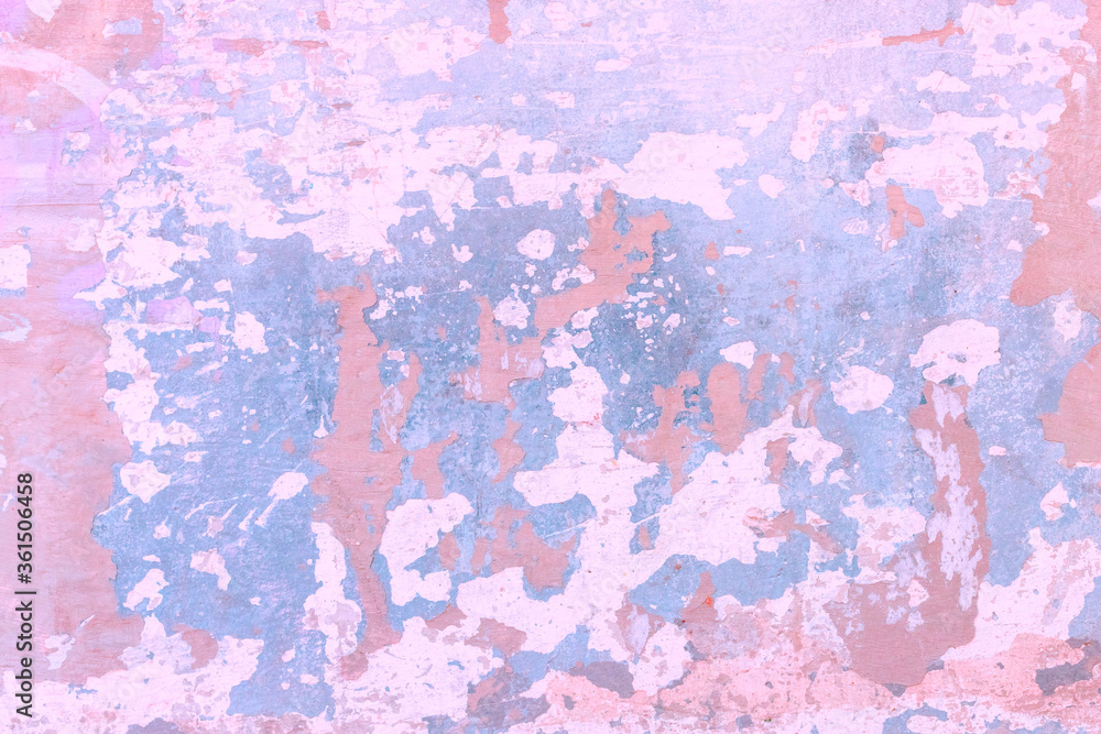 Background pink and light blue spots on cracked stucco.