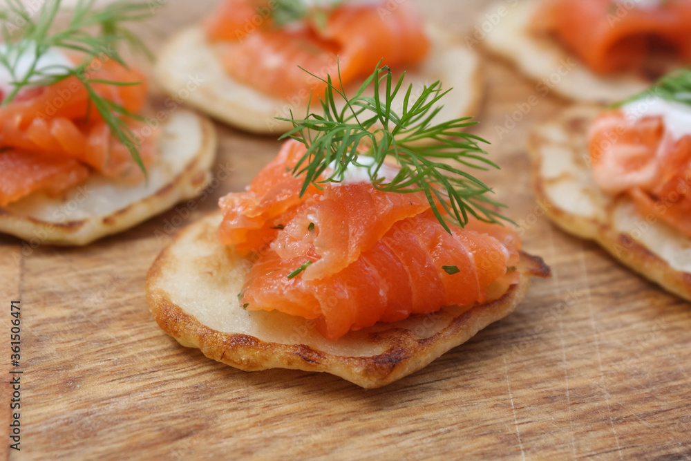 Pancakes with salted salmon on a wooden Board Pancakes with salted salmon on a wooden Board