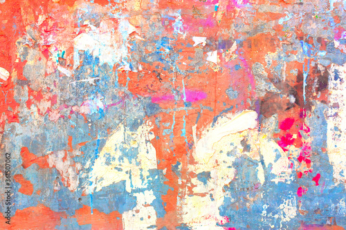 Old concrete wall covered with colorful paint.