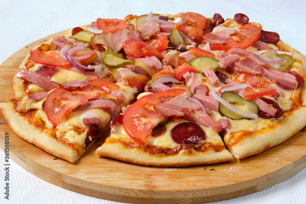 Tasty sliced Pizza with mozzarella, tomatoes, onion and sausages. Delicious Italian food. Cafe, pizzeria and restaurant menu. Tasty sliced Pizza with mozzarella, tomatoes, onion and sausages. Delicious Italian food. Cafe, pizzeria and restaurant menu.