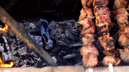 Coals and barbecue. Mixing coals.